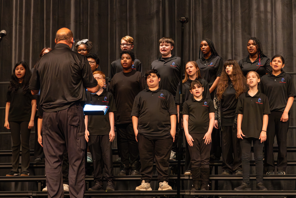 middle school choir performing on stage