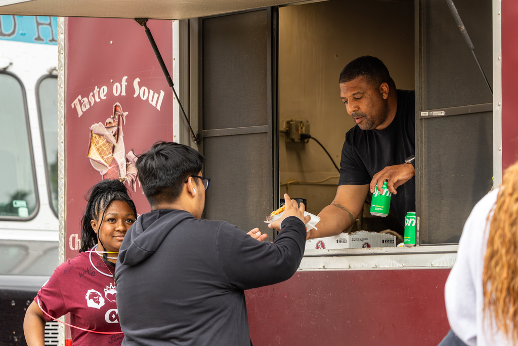 Students order food from a “Taste of Soul” food truck during the outdoor portion of the fundraiser.