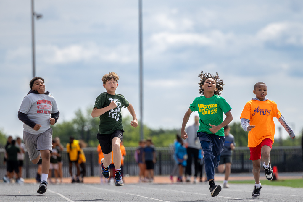 Elementary students sprint down the track during a race at the District elementary track meet.