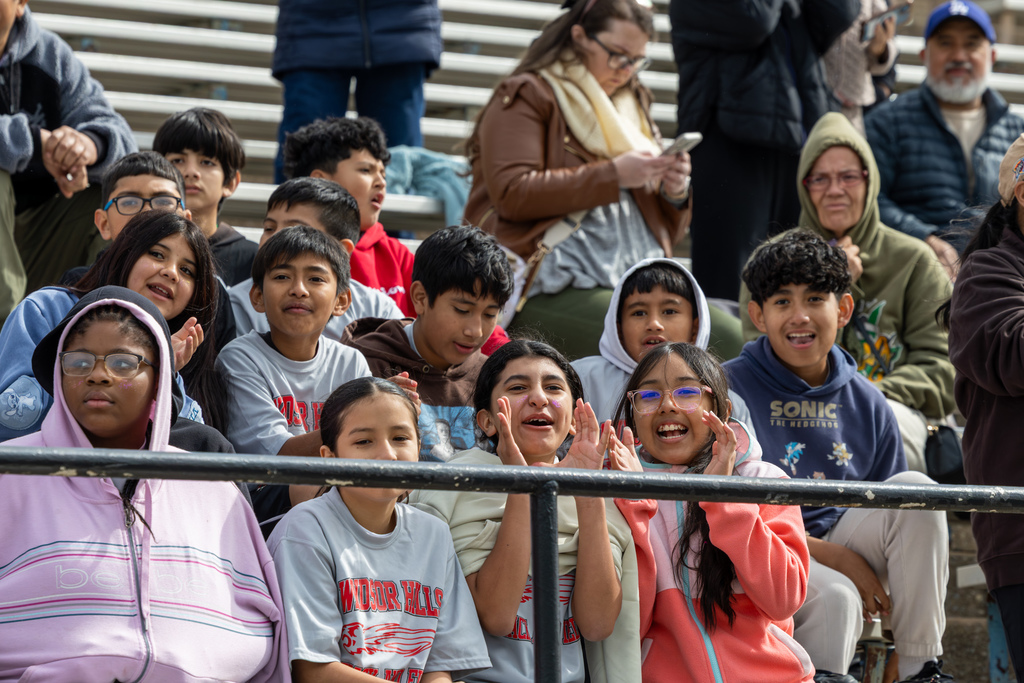 Windsor Hills Elementary students sit in the bleachers, cheering and watching events during the elementary track meet.