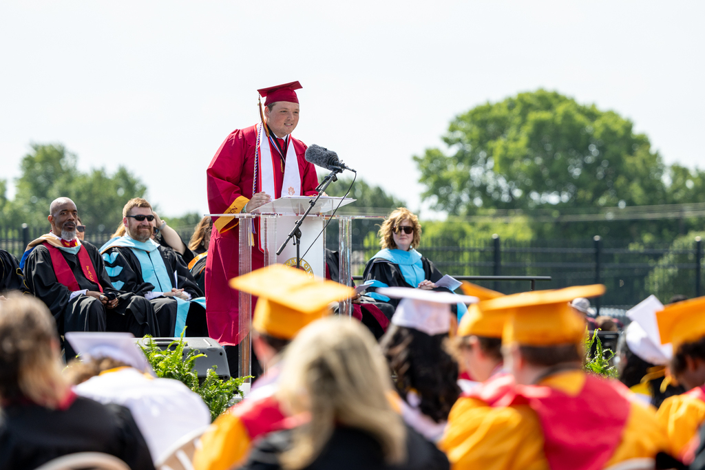 A Putnam City North graduate speaks at the podium during the Class of 2026 graduation ceremony.
