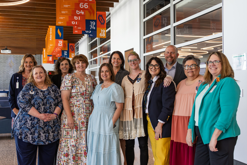 A group of Putnam City administrators poses together in the Centennial Center hallway after the All-Admin Workshop.