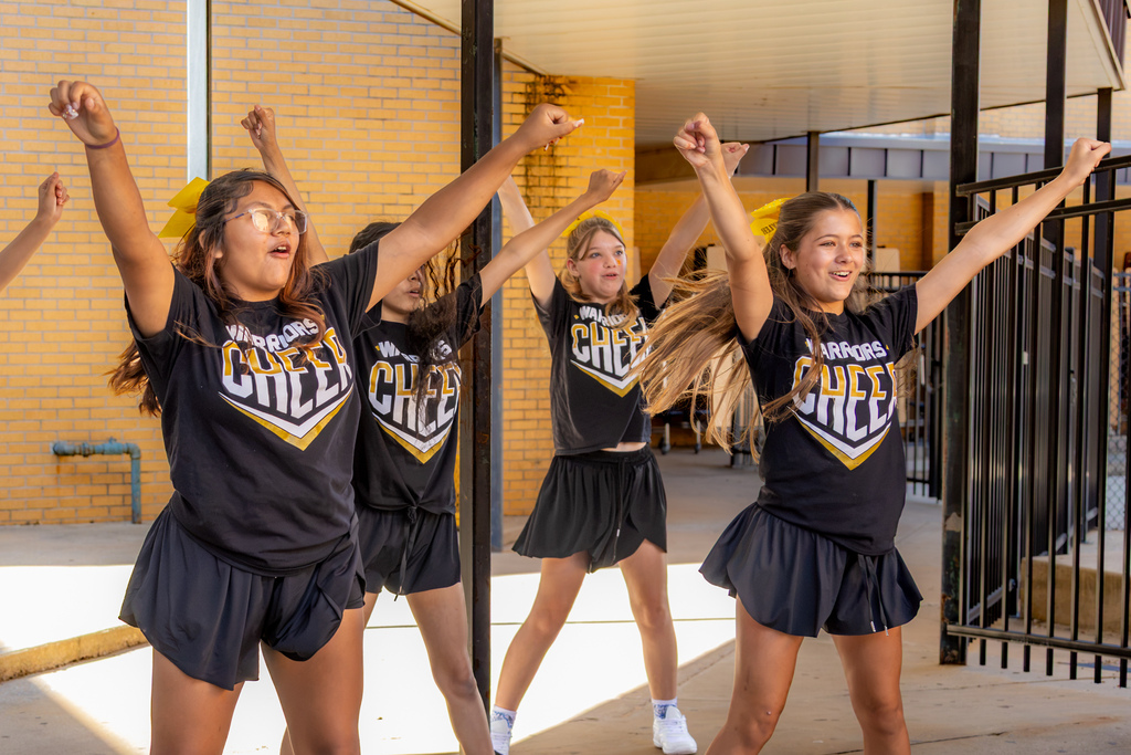 Western Oaks Middle School cheerleaders perform outside during the back-to-school event.