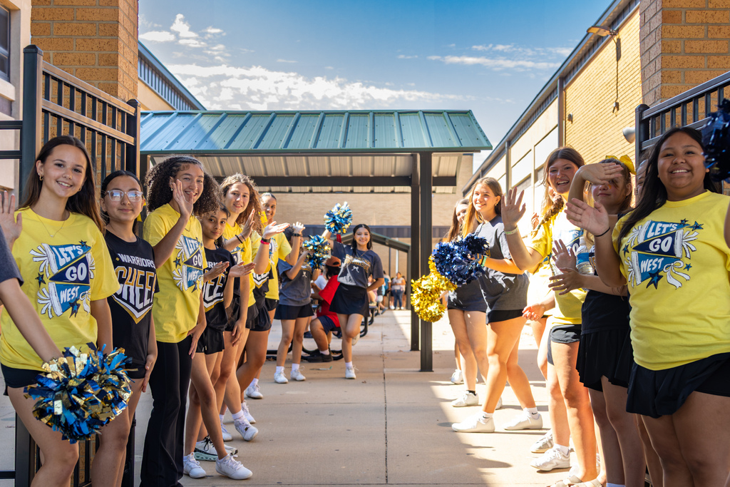 Western Oaks Middle School cheerleaders line the walkway and welcome families arriving at the back-to-school event.