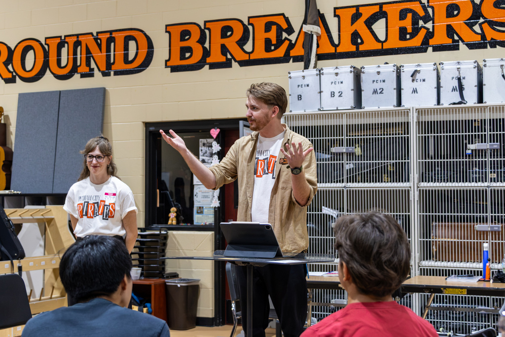 Putnam City High School orchestra director speaks to Symphony Orchestra students as they celebrate being selected to headline the 2027 OkMEA Winter Conference.