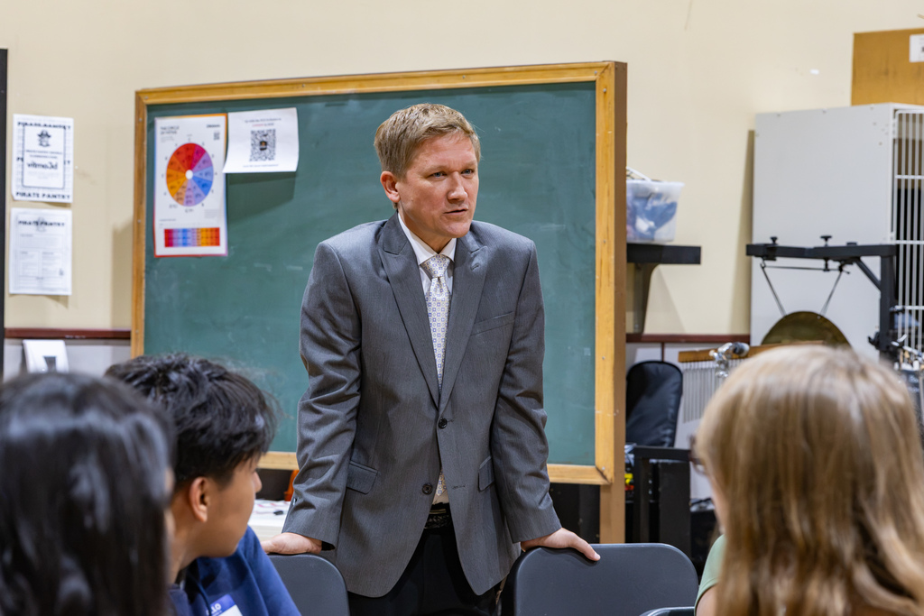 Putnam City High School Assistant Principal Isaac McCord speaks with Symphony Orchestra students during the surprise OkMEA announcement.
