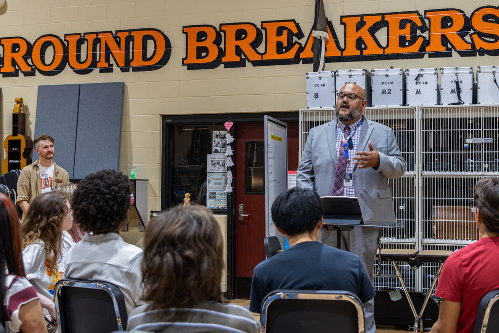 Putnam City High School Principal Christian Vargas addresses Symphony Orchestra students after their selection to headline the 2027 OkMEA Winter Conference is announced.