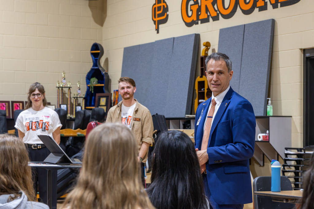 Putnam City Schools Superintendent Dr. Kenny Rodrequez speaks to Putnam City High School Symphony Orchestra students following the announcement of their selection for the 2027 OkMEA Winter Conference.