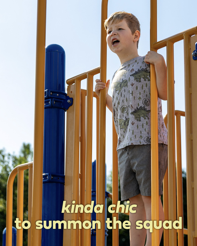 A student calls out from elevated playground equipment while classmates play nearby. Text reads, “kinda chic to summon the squad.”