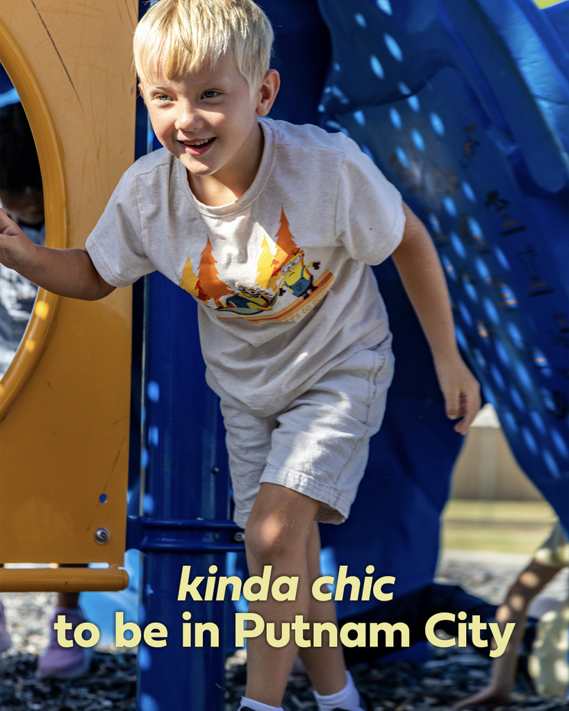 A smiling student stands outdoors on the Arbor Grove Elementary playground. Text reads, “kinda chic to be in Putnam City.”
