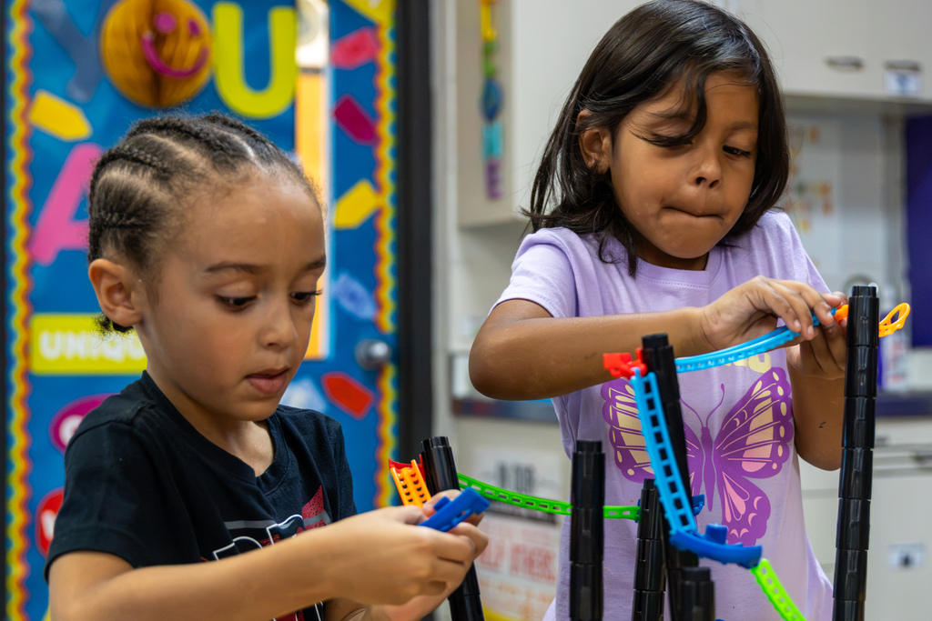 Two Rollingwood Elementary students carefully connect pieces to a roller coaster track during Mrs. Wade’s STEM class.