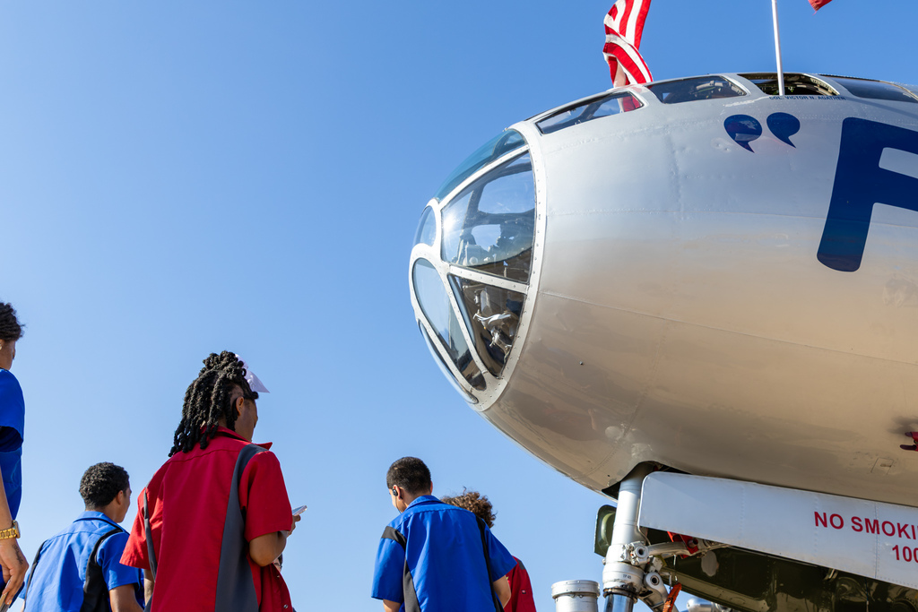 Putnam City Aviation students walk beneath the nose of the B-29 FIFI.