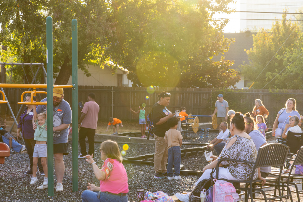 Families and students visit together across the DD Kirkland playground during the morning Goodies with Grands event.