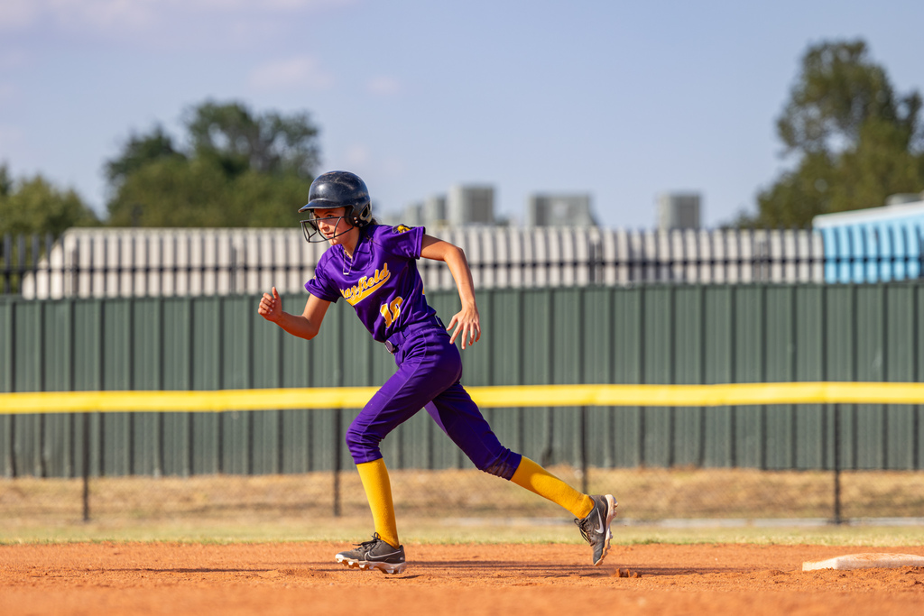 A Mayfield runner sprints between bases during the game against Western Oaks.