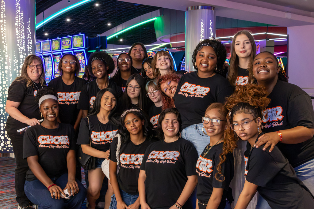 Putnam City High School choir students and their director pose together inside Riverwind Casino after their performance with Foreigner.
