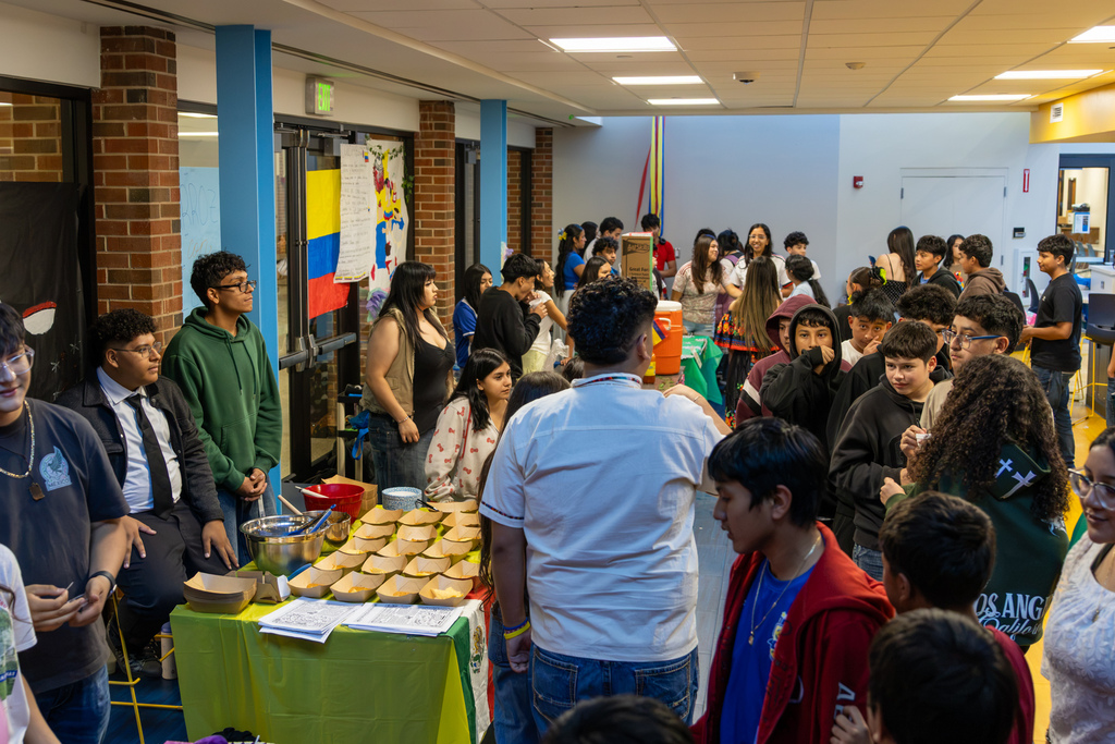 Putnam City West is filled with students visiting cultural booths and sampling food during the Living Museum.
