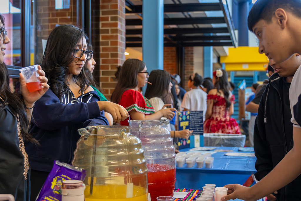 Students serve colorful drink samples to visitors during Putnam City West’s Hispanic Heritage Month Living Museum.