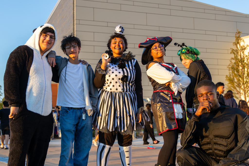 A group of PC West high school students pose together in creative Halloween costumes outside the Centennial Center.
