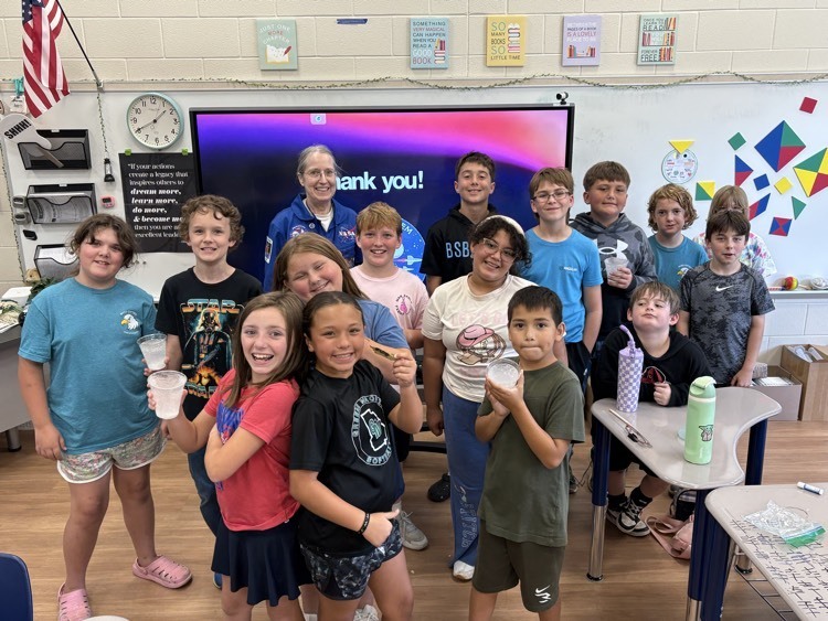 students in a classroom with an astronaut