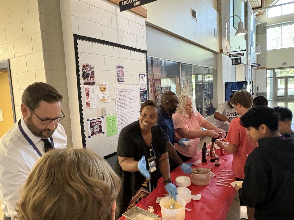 Students being served their ice cream by administration