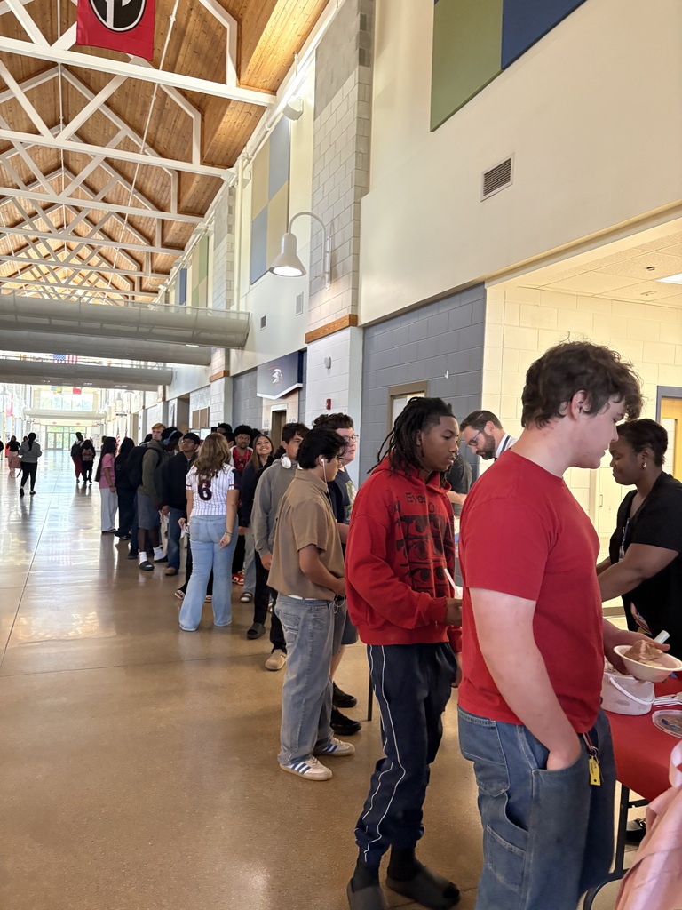 Large line of students with perfect attendance that are receiving their reward