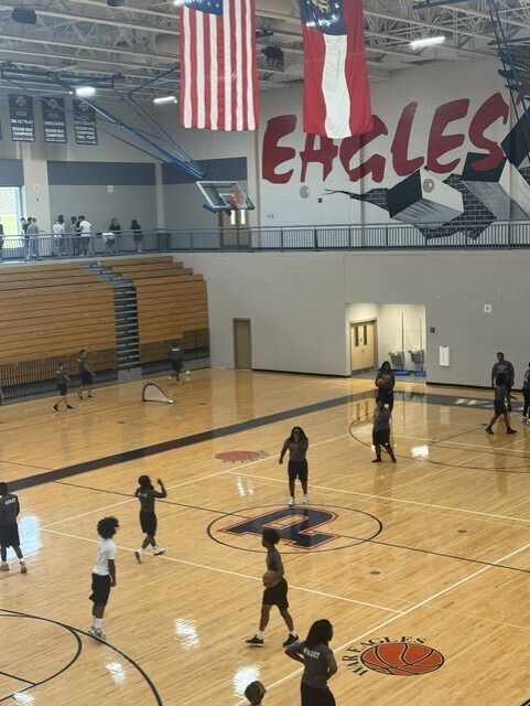 Students in Gym playing basketball