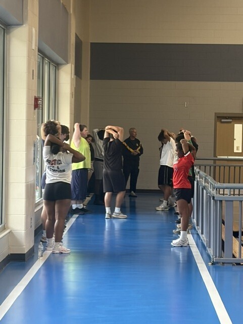 Students in gym stretching