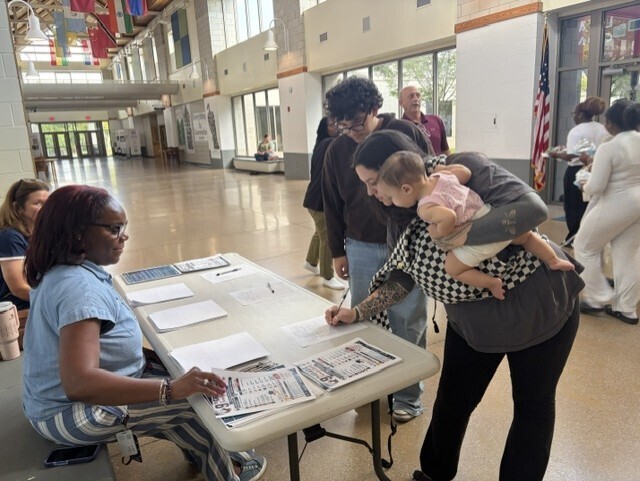 family at registration table