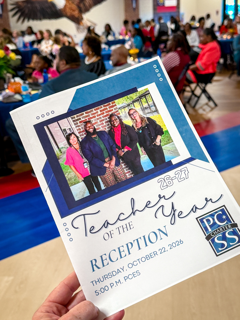 Hand holding program for "Teacher of the Year Reception". Photo shows four teachers standing together.