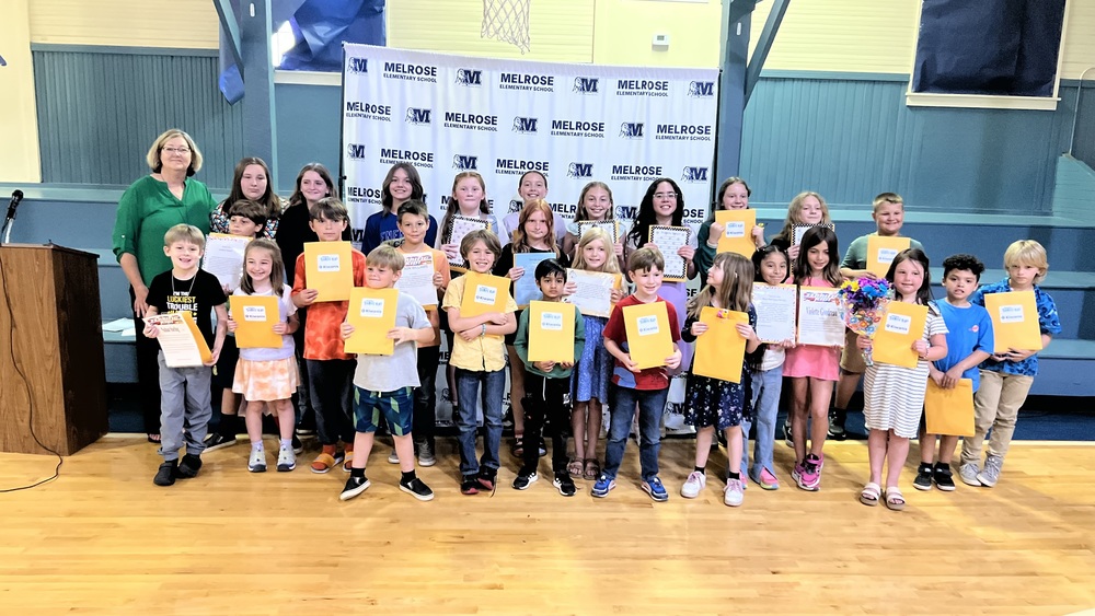 picture of 27 students and one adult holding up their Terrific Kid folders.  