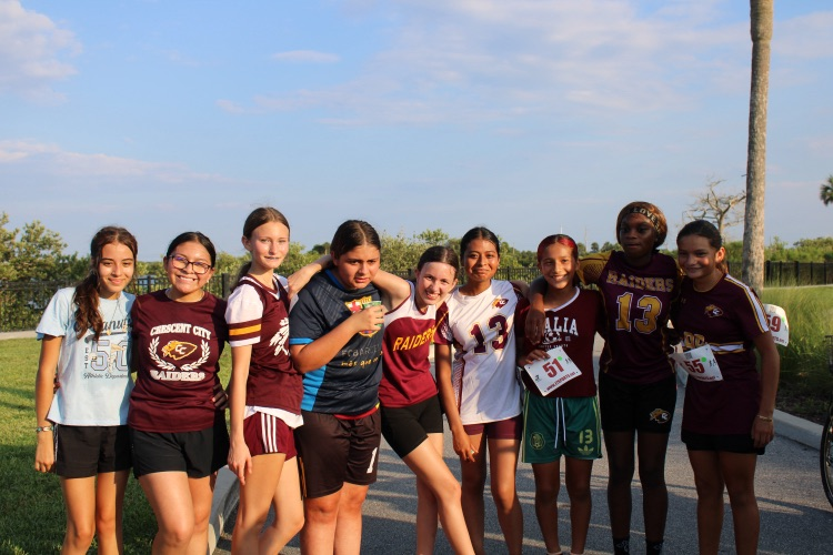 Girls cross country team poses for picture.