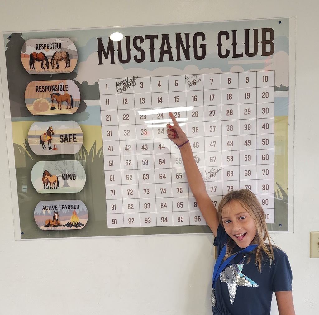 picture of female student pointing at Mustang Club bingo board
