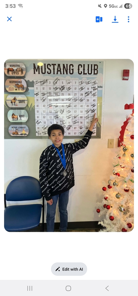 picture of male student pointing at Mustang Club board