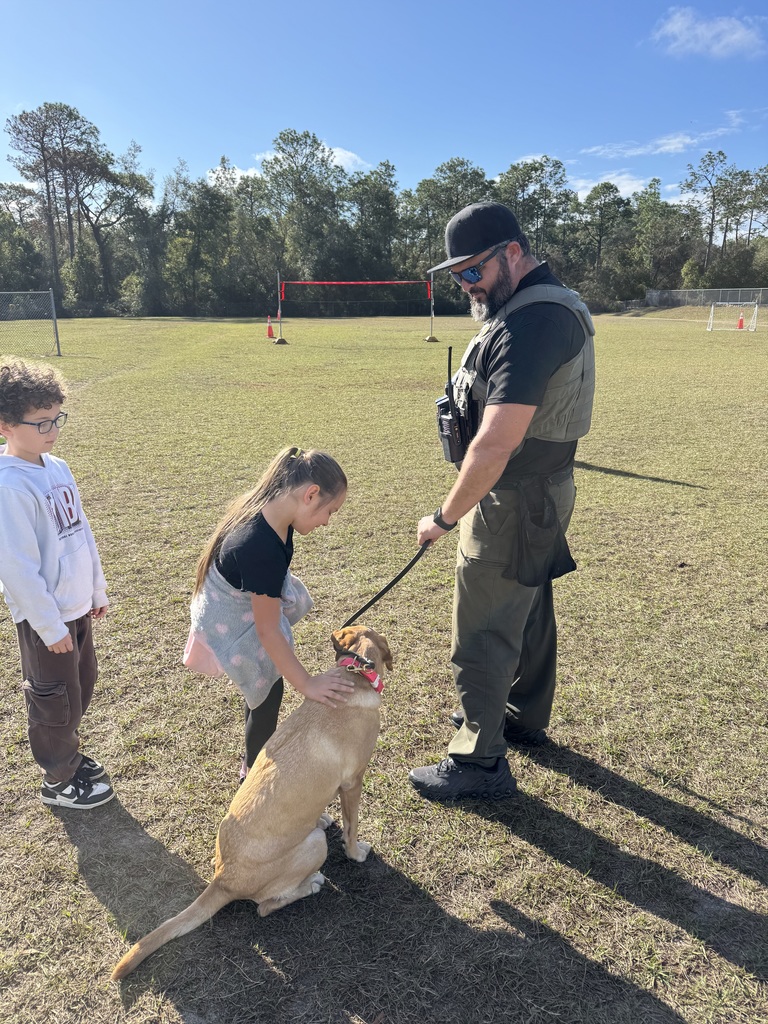 deputy with dog and girl