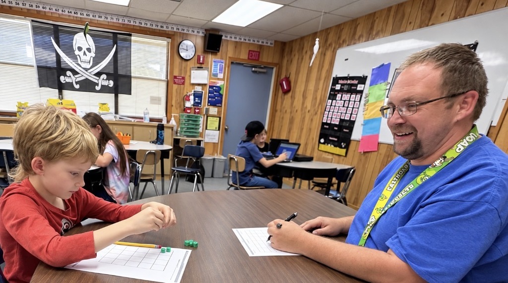 Mr. Johns working with his students in math class.
