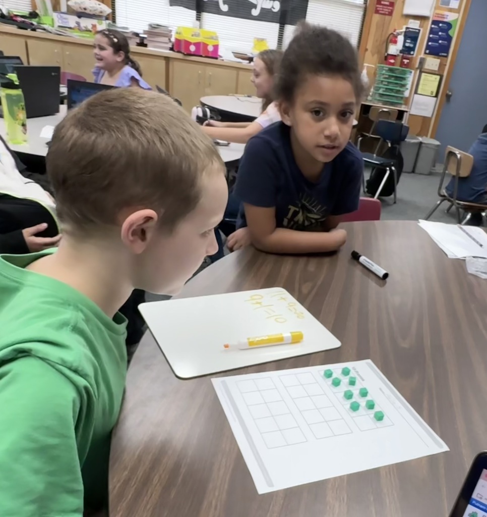Mr. Johns working with his students in math class.