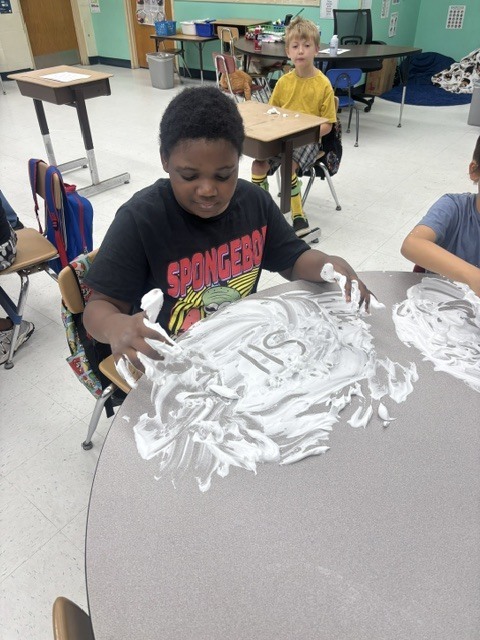 Mr. Geer's class working on sensory spelling