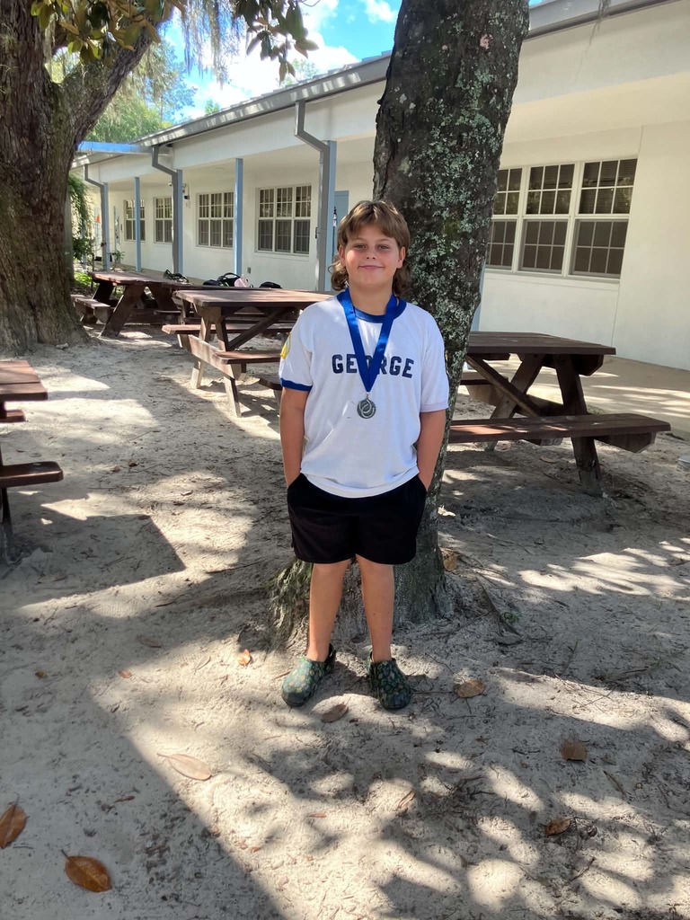 Picture of male student standing with Mustang Club medal