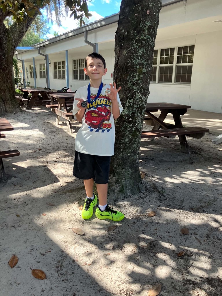 Picture of male student standing with Mustang Club medal