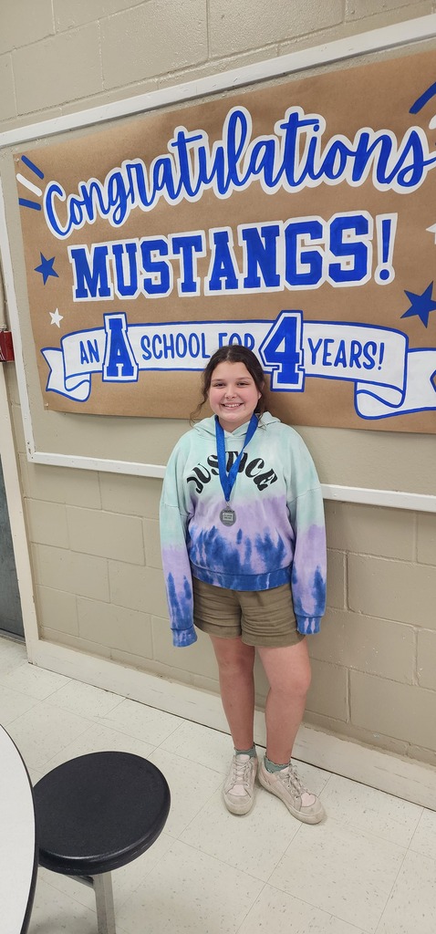 Picture of female student standing with Mustang Club medal