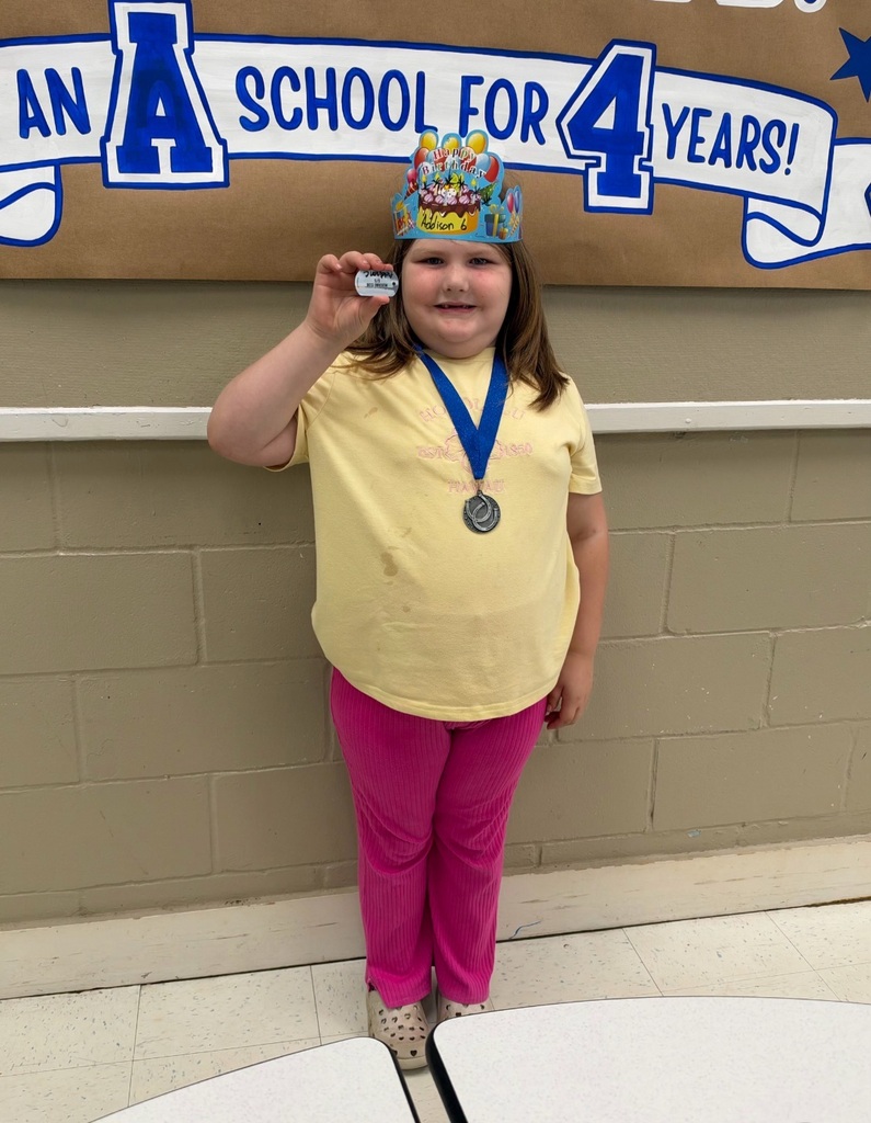 Picture of female student standing with Mustang Club medal