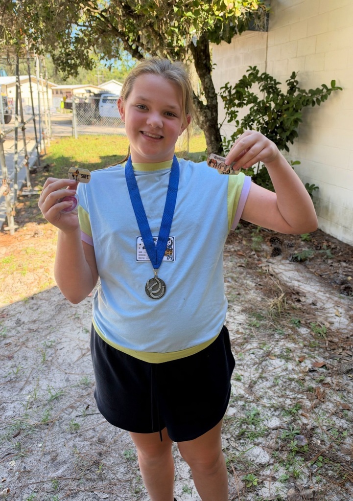 Picture of female student standing with Mustang Club medal