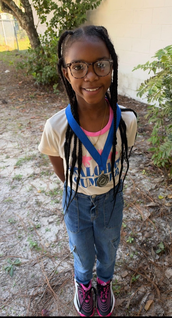Picture of female student standing with Mustang Club medal