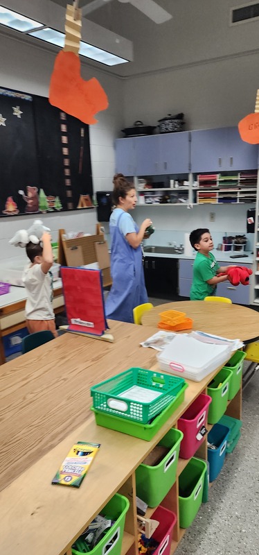 picture of kindergarten students walking in a parade with their stuffed animals.