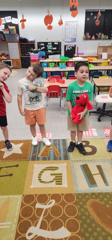 picture of Kindergarten students walking in a parade with their stuffed animals