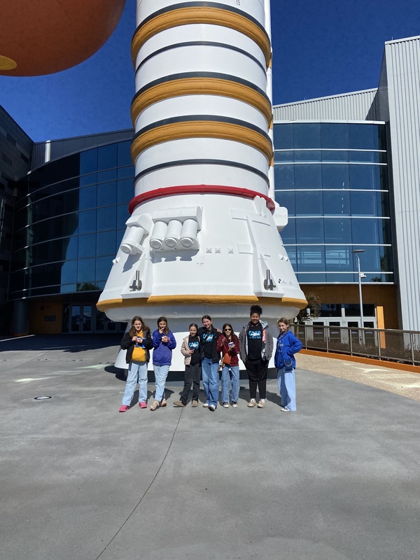 picture of students in front of rocket