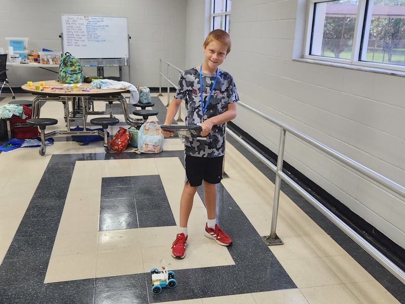 Joshua Payne demonstrates the robot he built.