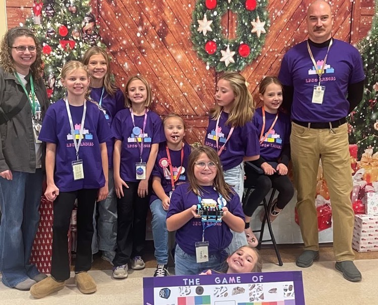 students standing in front of Christmas board 