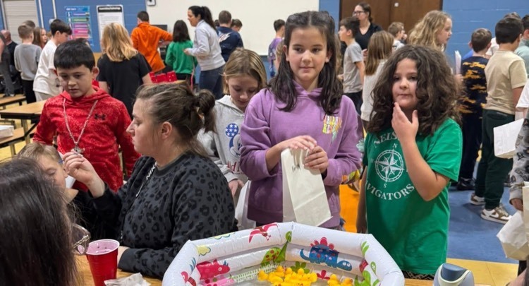 students choosing a duck from baby pool