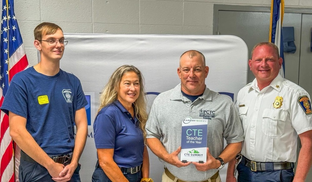 Darin Virag Holding CTE Teacher of the Year plaque